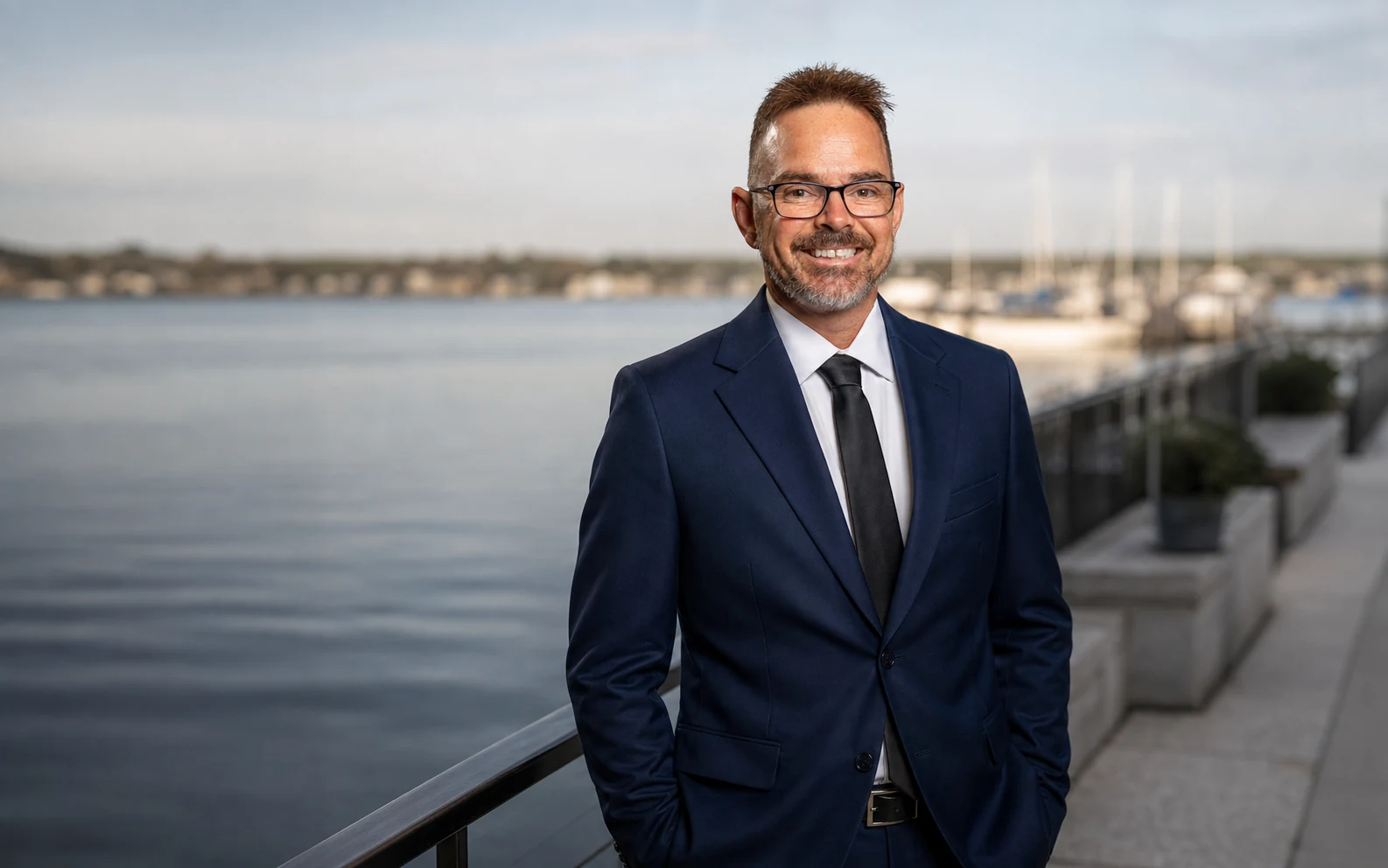 Pete Carter in a navy suit at a waterfront