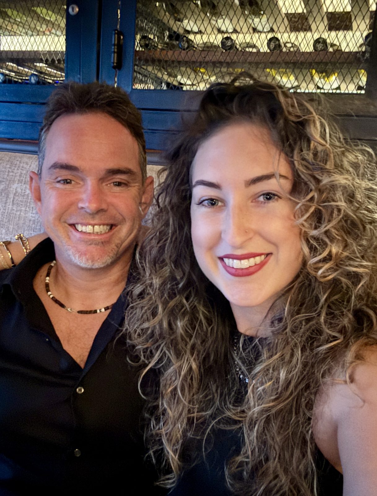Pete and Danielle smiling together at a restaurant