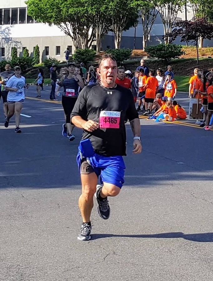 Pete running a 10K race wearing bib number 4465